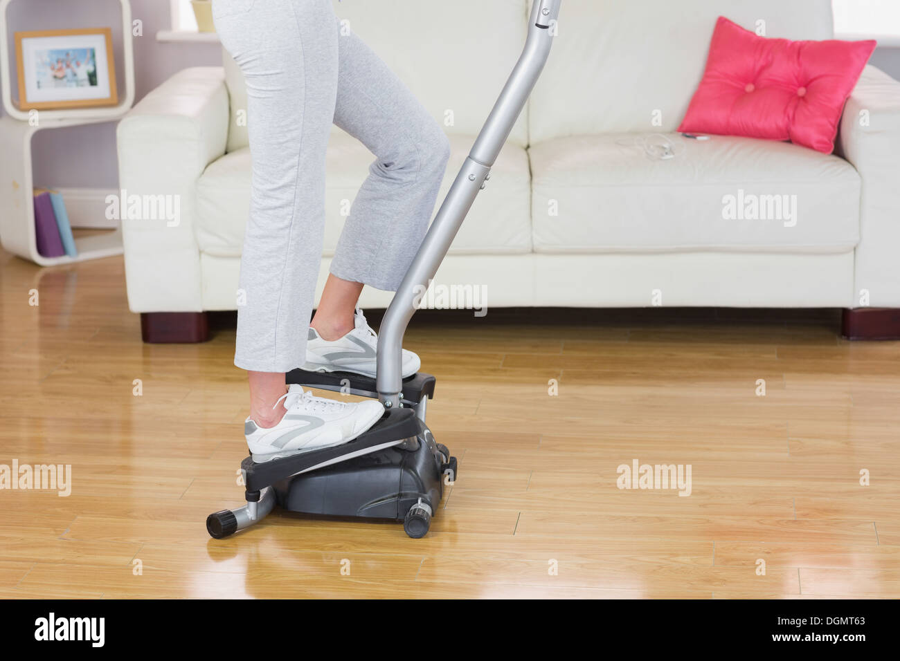 Sporty woman exercising on step machine Stock Photo - Alamy