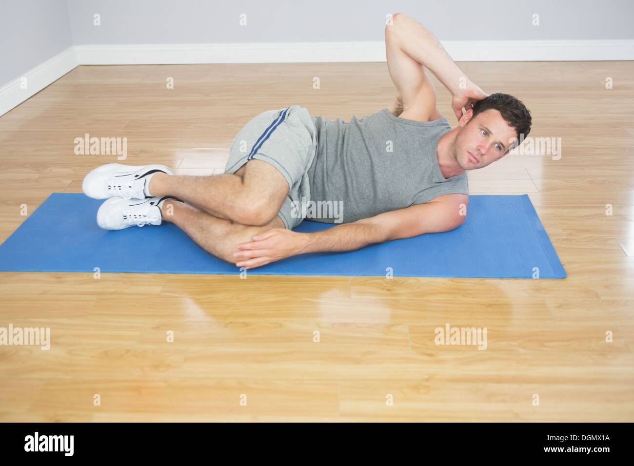 Attractive sporty man doing abdominal crunch Stock Photo