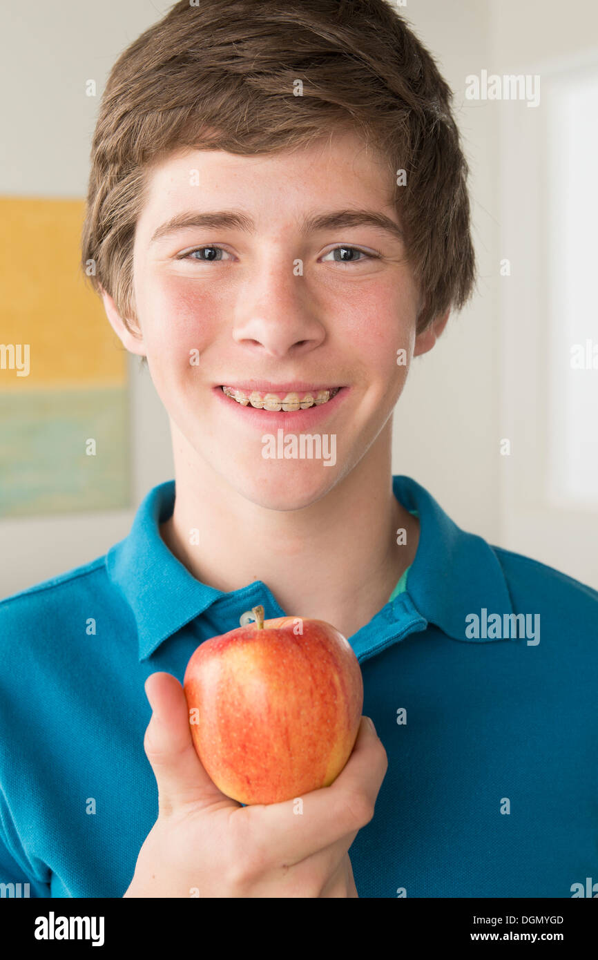 Boy (14-15) holding apple Stock Photo