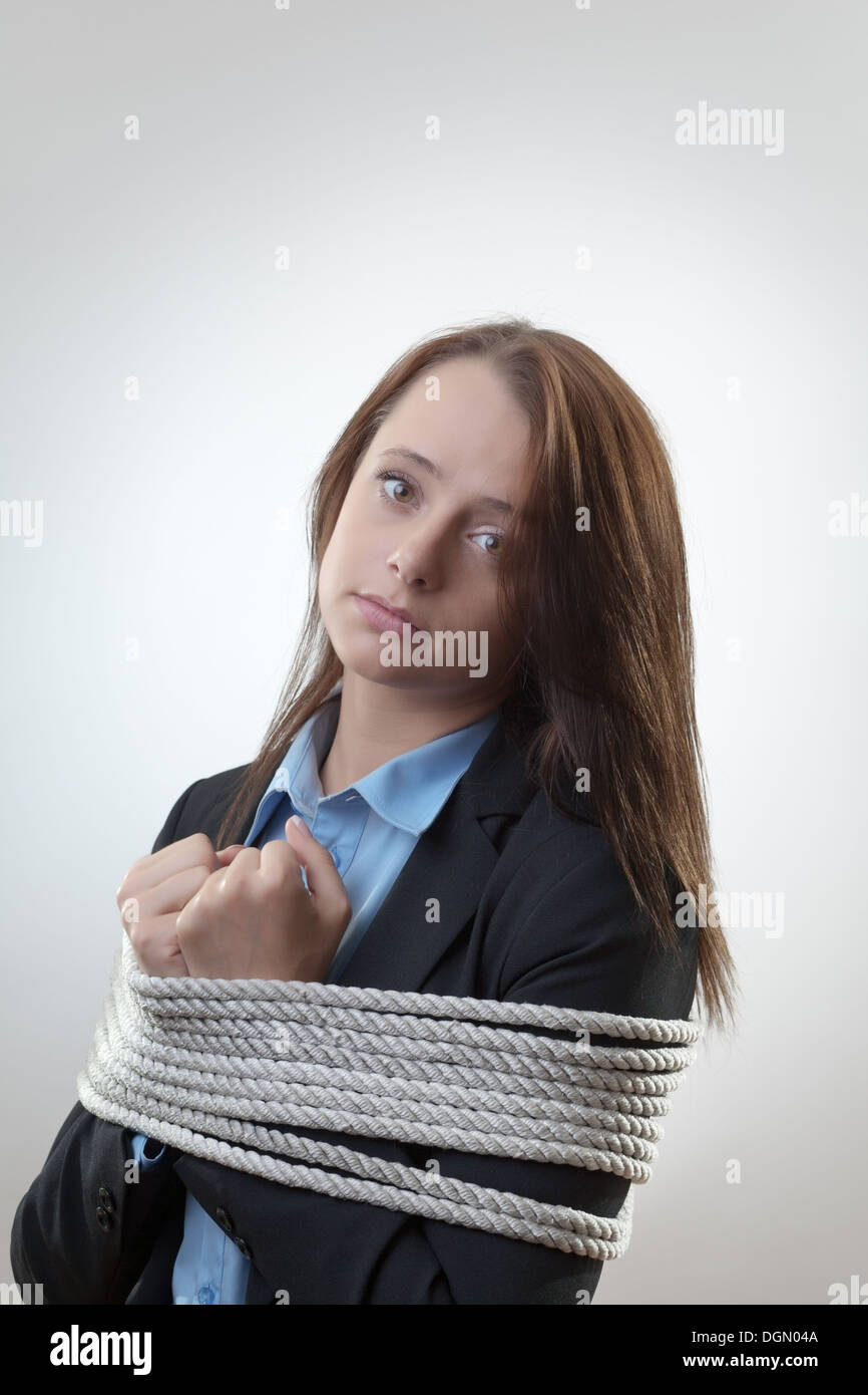 bound by rope businesswoman tied maybe for a corporate crime  Stock Photo