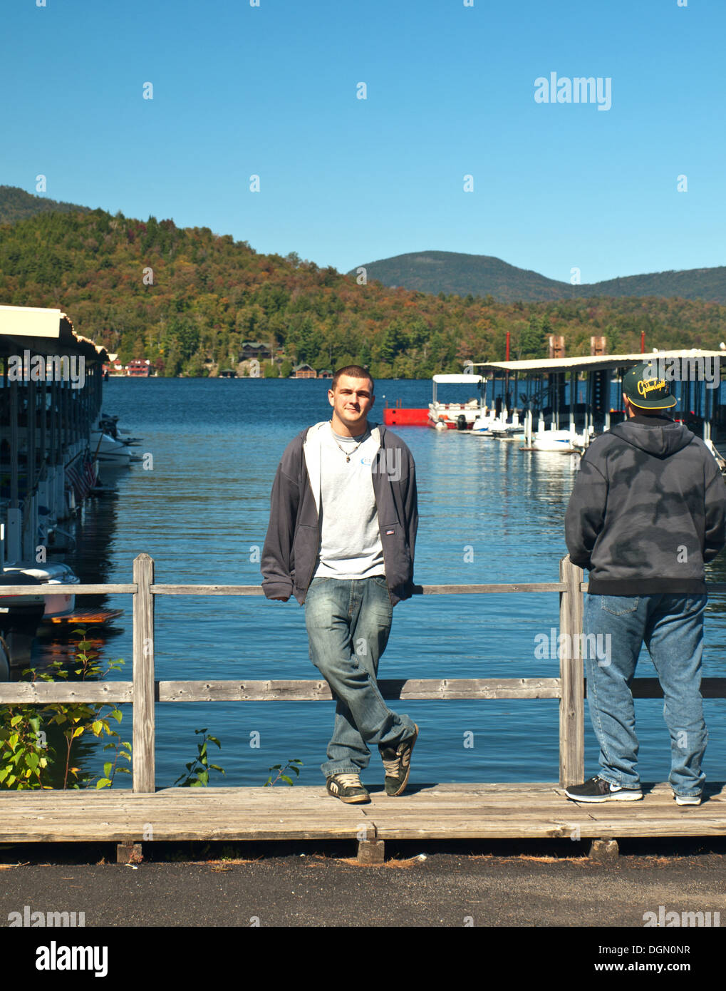 teenage boys by boat docks at the lake placid marina in lake placid