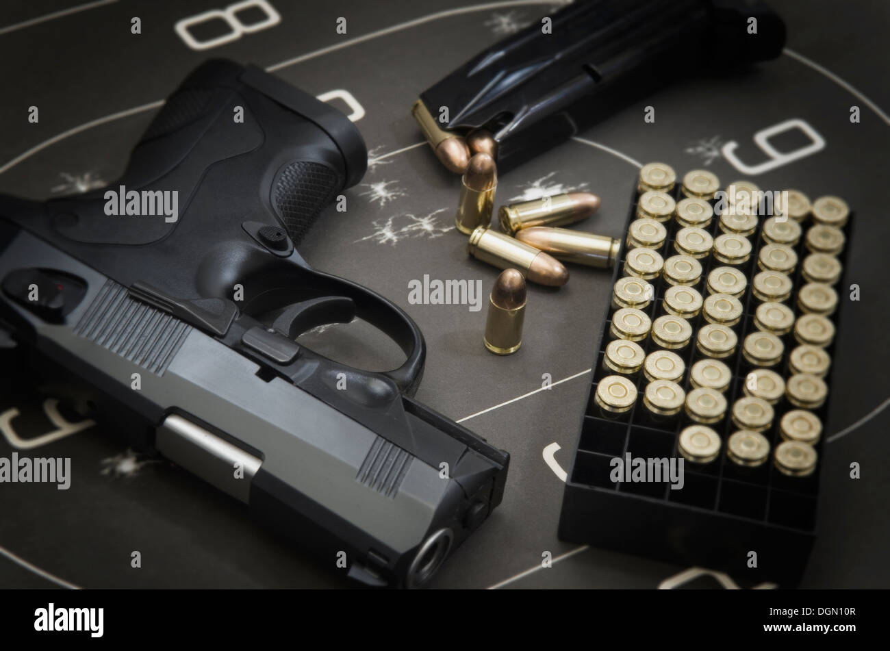 Beretta 9mm PX4 Storm semi-automatic pistol with magazine and full metal jacket ammunition on background of shooting target Stock Photo