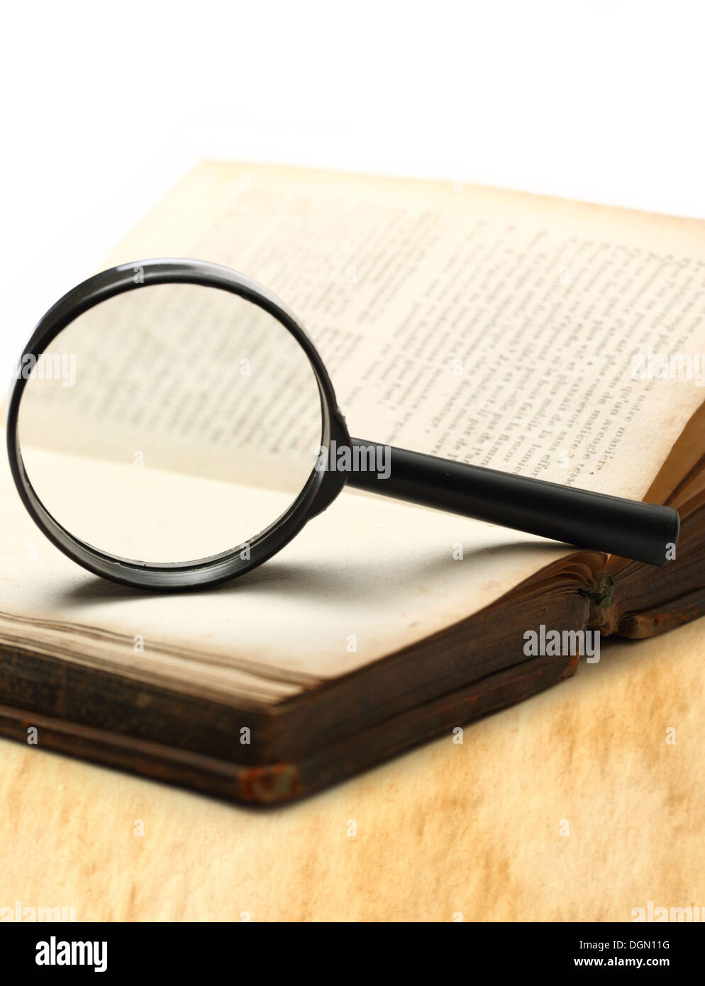 Magnifying glass and old book on the white background Stock Photo - Alamy