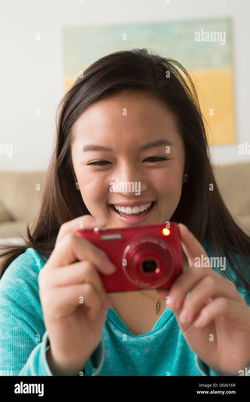 Portrait of teenage girl (16-17) with digital camera Stock Photo