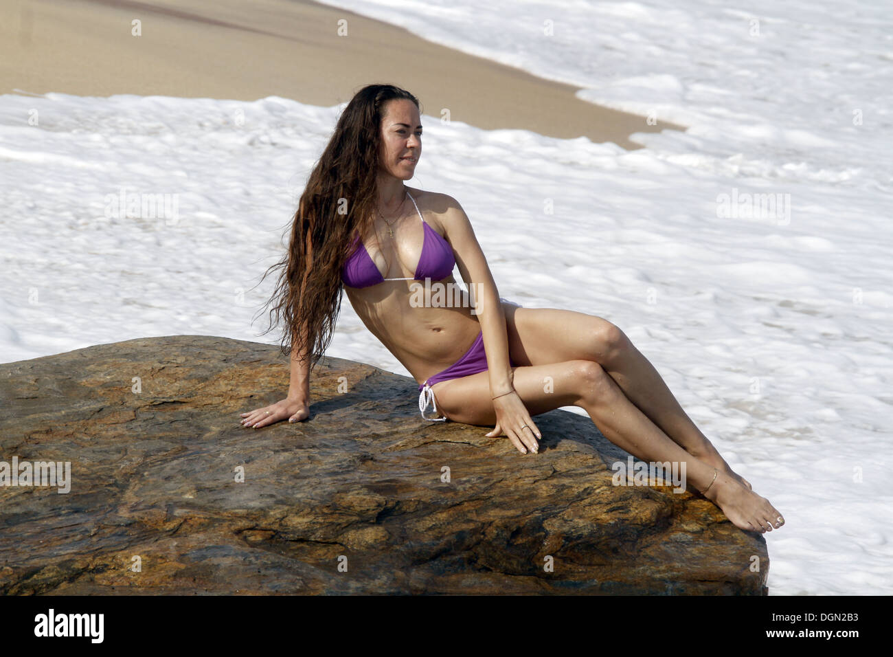 WOMAN IN PURPLE BIKINI & SURF TANGALLE SRI LANKA 16 March 2013 Stock