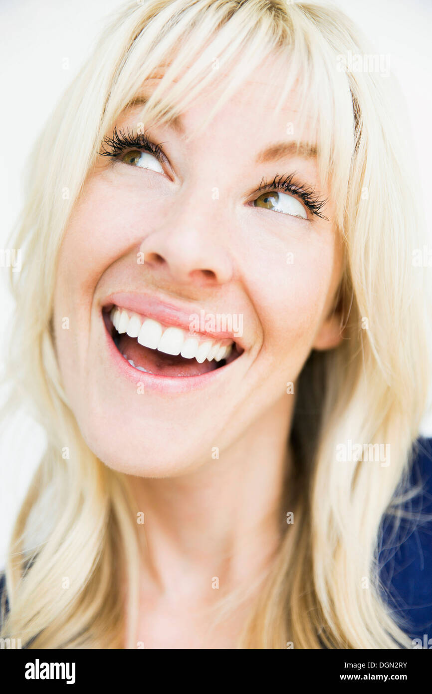 Studio portrait of cheerful blonde woman Stock Photo - Alamy