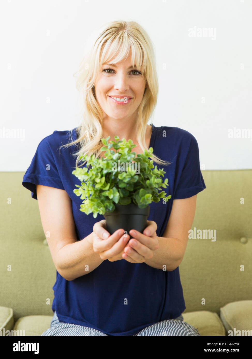 Woman holding potted plant Stock Photo - Alamy