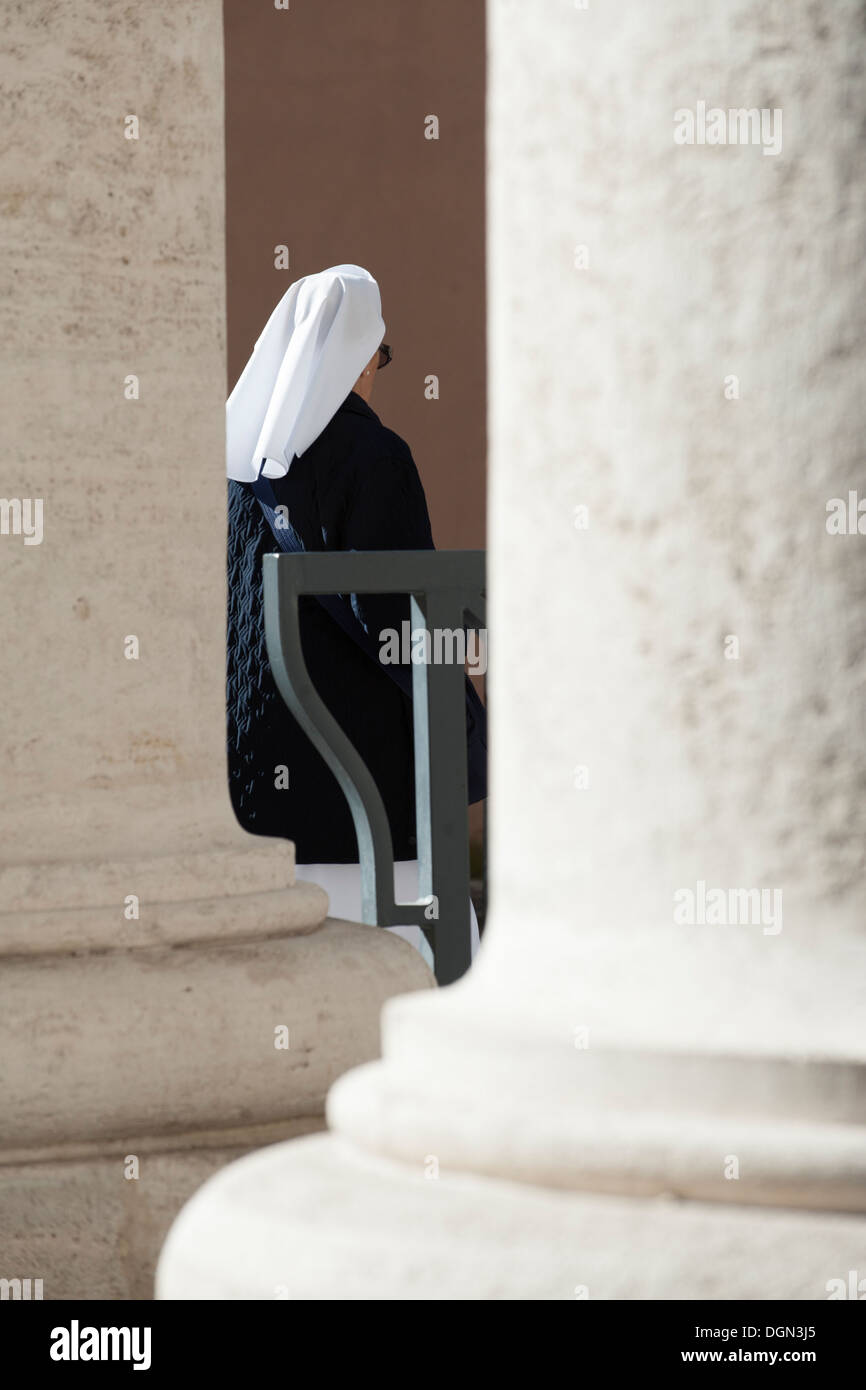 Nun walk in St Peter's colonnades Stock Photo