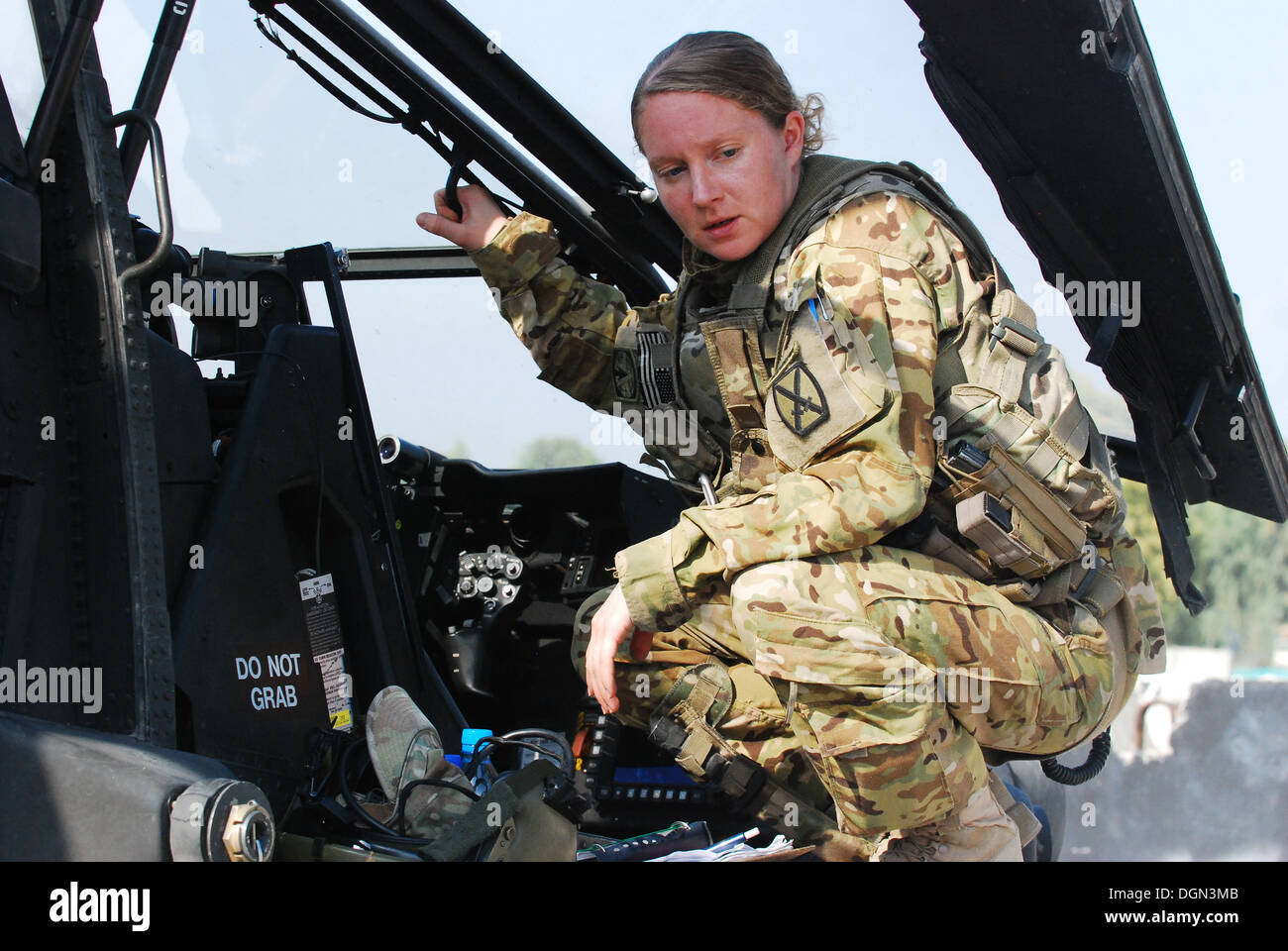 Capt Megan Howell, an AH-64 Apache helicopter pilot from 1st Attack/Reconnaissance Battalion, 10th Combat Aviation Brigade, pauses to catch her breath following a security and reconnaissance mission, Oct. 11, at Forward Operating Base Fenty, Afghanistan. Stock Photo