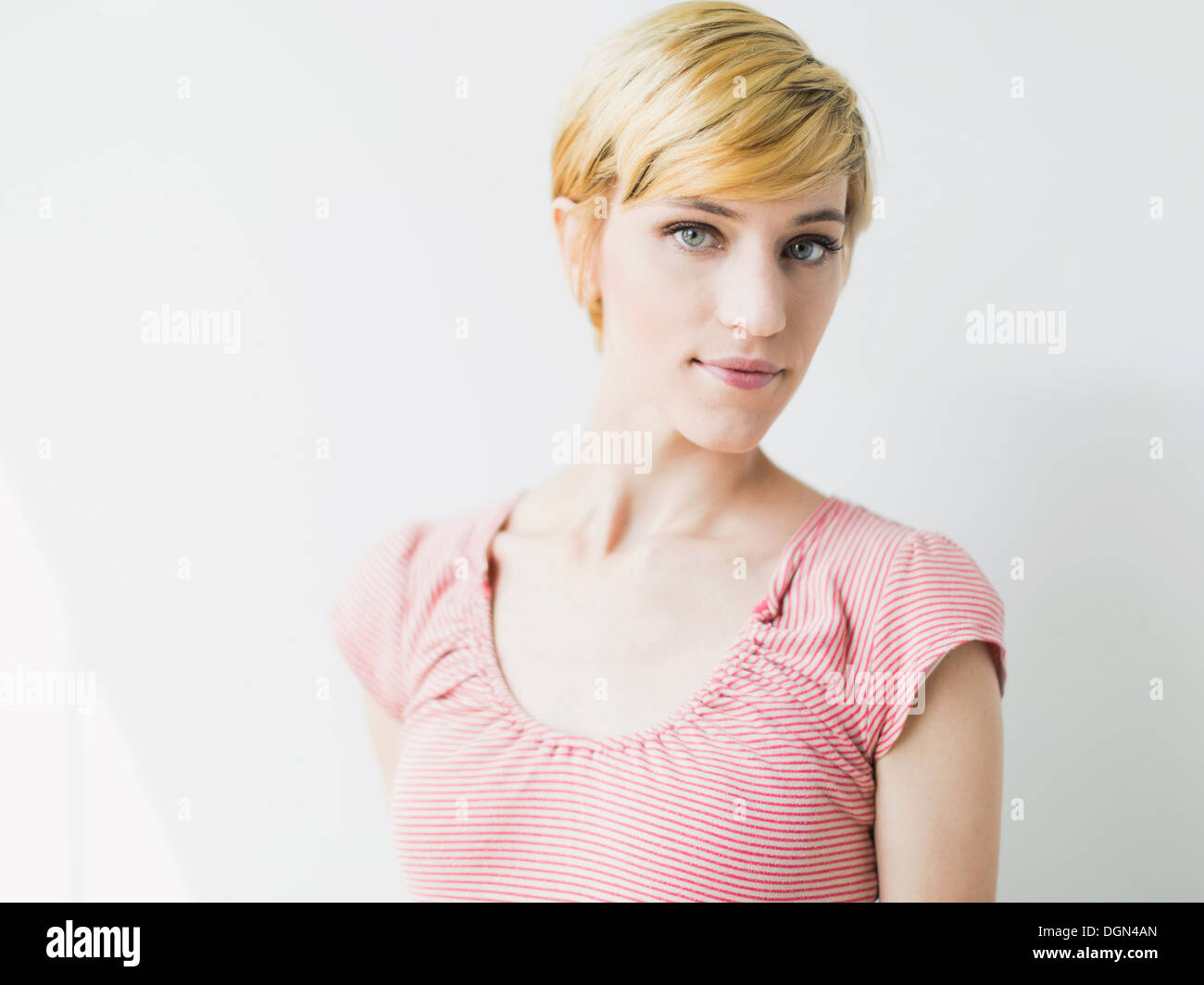 Portrait of young smiling woman, studio shot Stock Photo