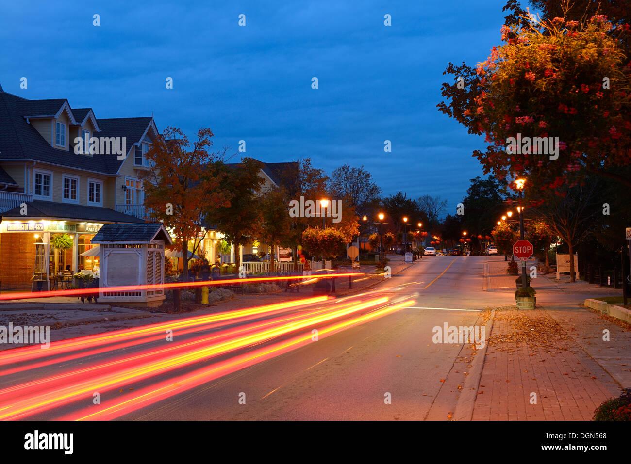 Car taillight streaks at dusk with shops in Kleinburg Ontario Stock Photo