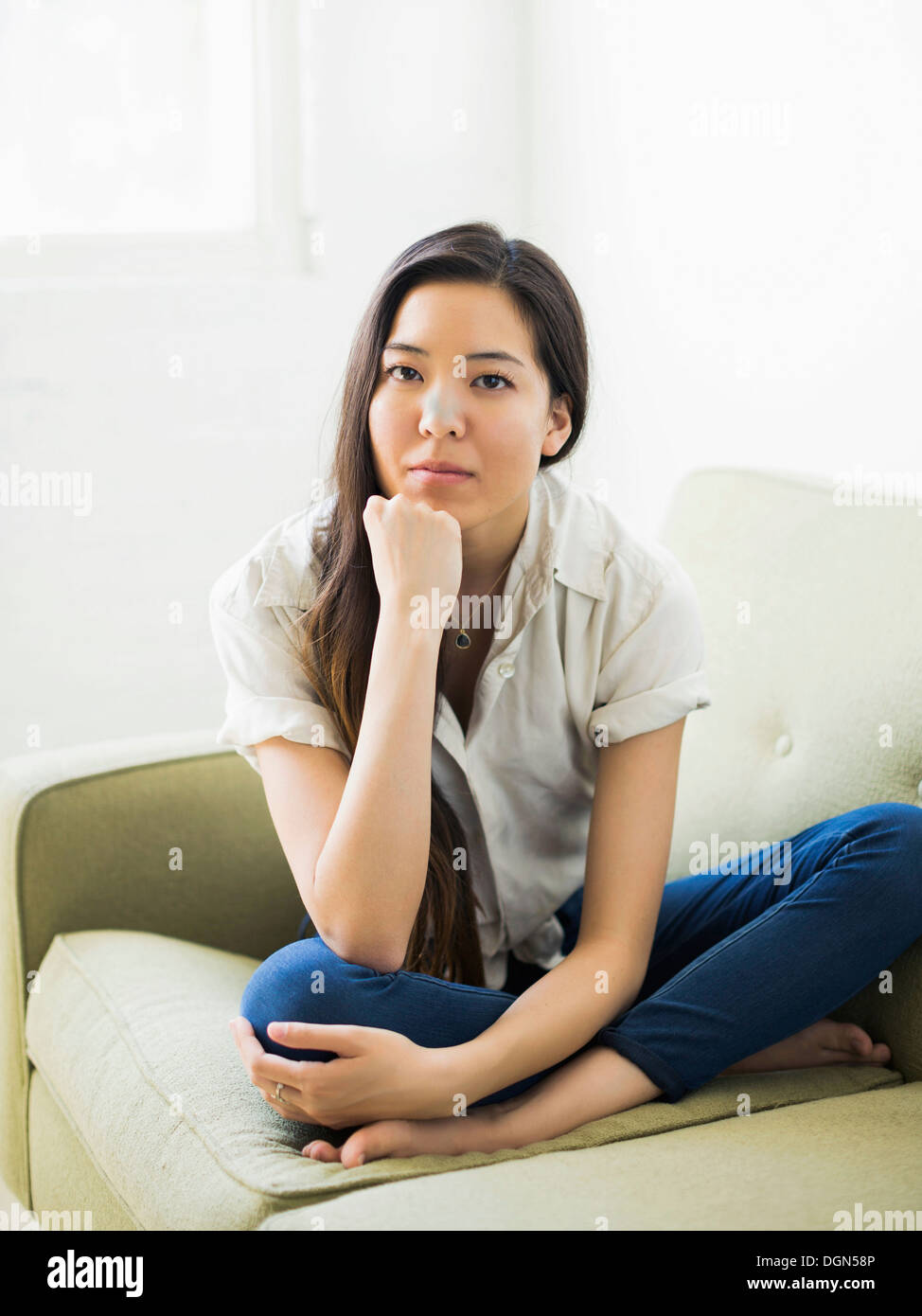 Casual woman sitting on sofa hi-res stock photography and images - Alamy