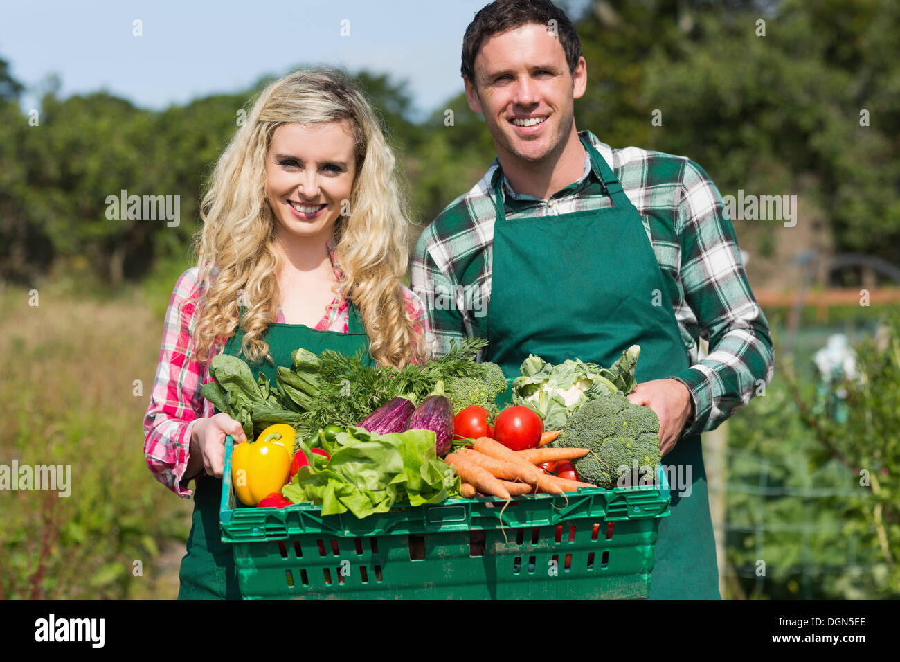 Proud young couple showing vegetables Stock Photo - Alamy
