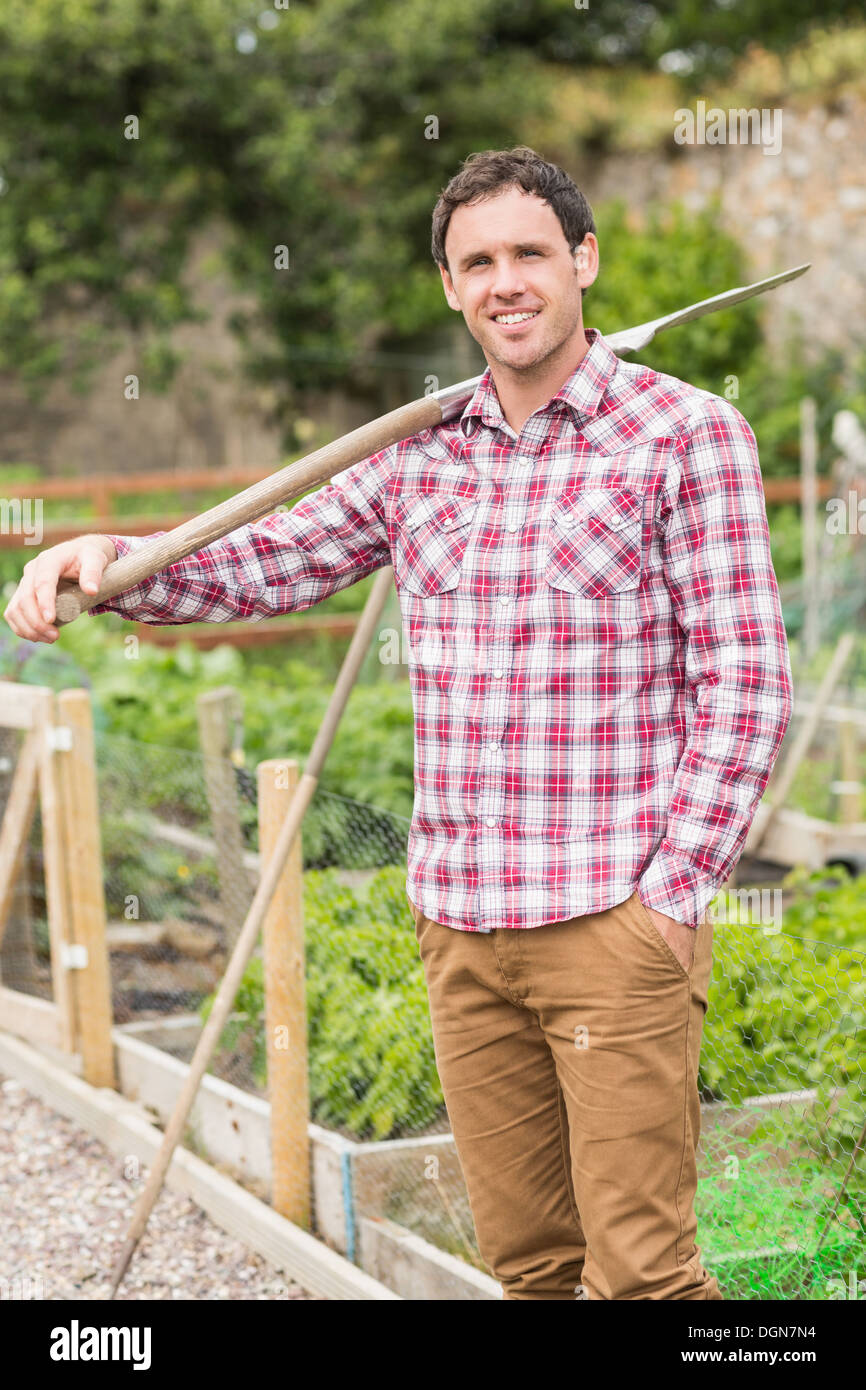 Young brunette man posing with a shovel Stock Photo - Alamy