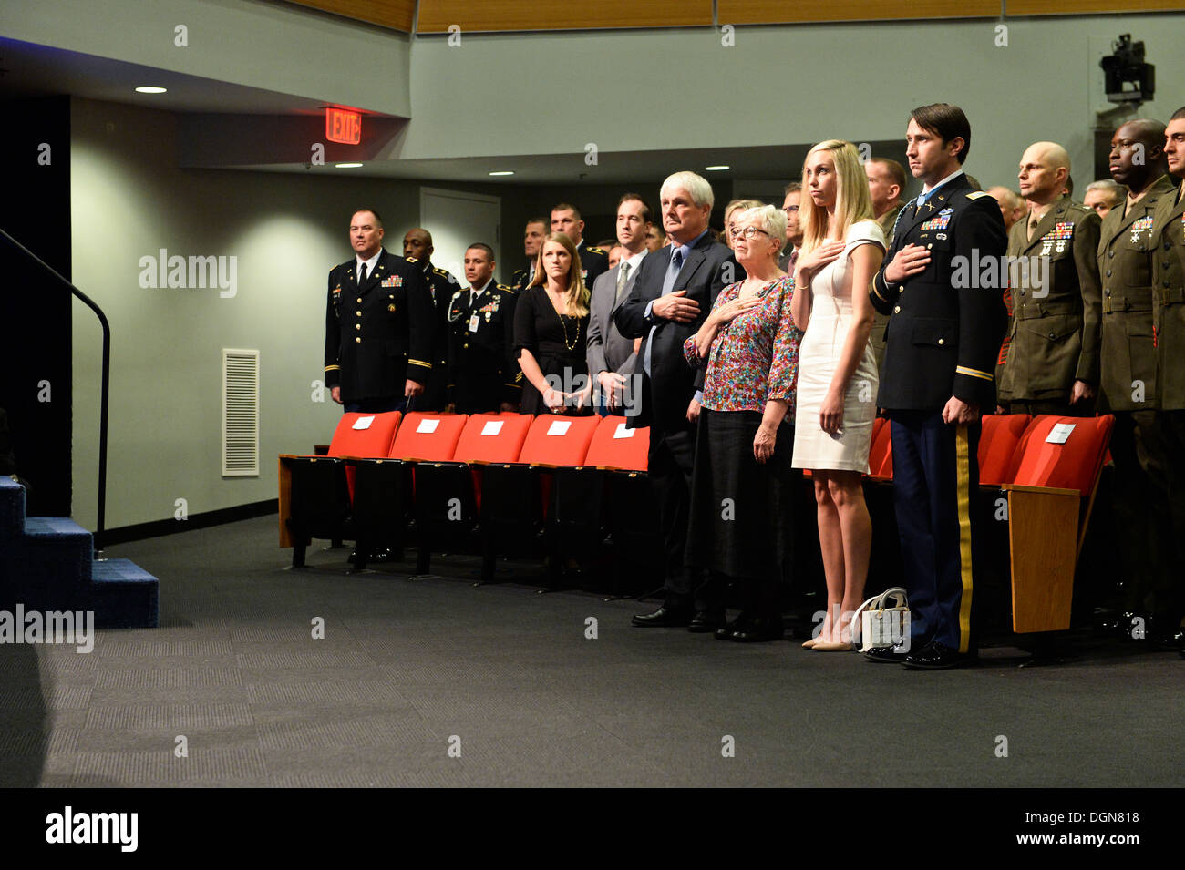 Former U.S. Army Capt. William D. Swenson, a Medal of Honor recipient, and his family stand for the national anthem during his Hall of Heroes induction ceremony at the Pentagon in Washington, Oct. 16, 2013. Stock Photo