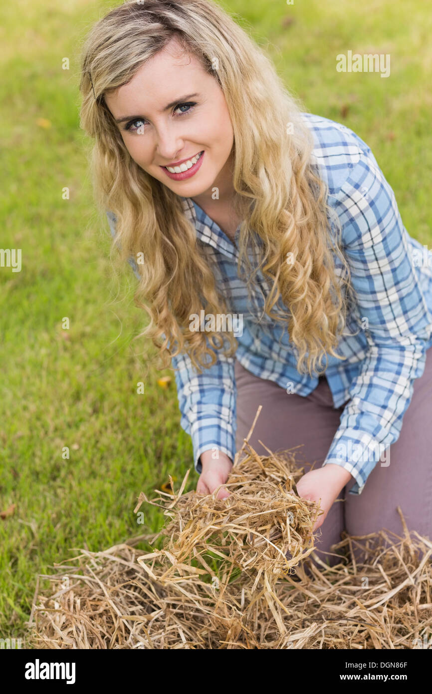 Pretty blonde feeling yellow straw Stock Photo