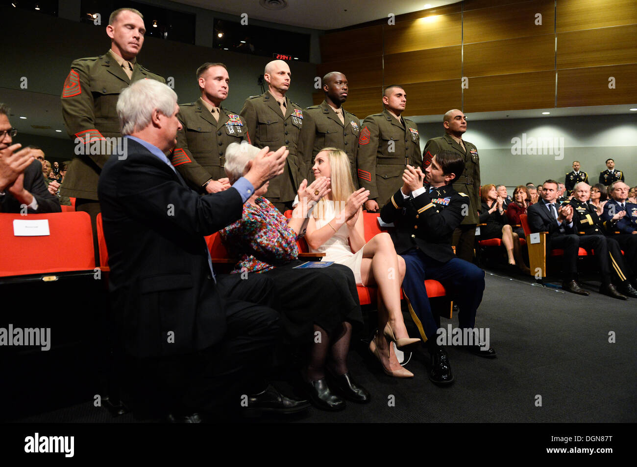 Former U.S. Army Capt. William D. Swenson, a Medal of Honor recipient, and his family applaud members of his team during the battle of Ganjgal at his Hall of Heroes Induction ceremony at the Pentagon in Washington, D.C., Oct 16, 2013. Stock Photo