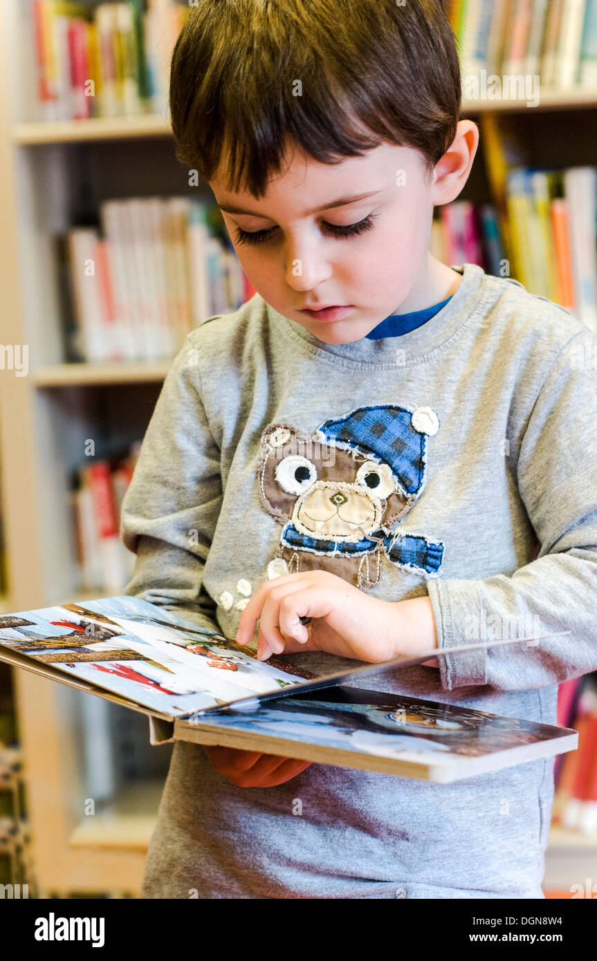 Child reading book at the public library Stock Photo