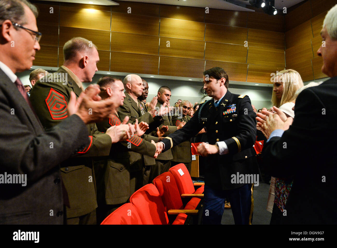 Former U.S. Army Capt. William D. Swenson, a Medal of Honor recipient, shakes hands with members of his team during the battle of Ganjgal at his Hall of Heroes Induction ceremony at the Pentagon in Washington, D.C., Oct 16, 2013. Stock Photo
