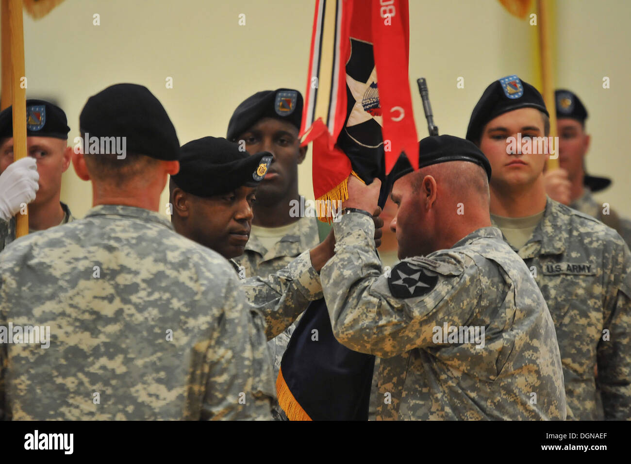 Command Sgt. Maj. Oscar Vinson passes the 4-2 Stryker Brigade Combat Team, 7th Infantry Division colors to Col. Michael Getchell for the last time during a Change of Command ceremony Oct. 16 at Soldiers Field House. Getchell served as the brigade commande Stock Photo