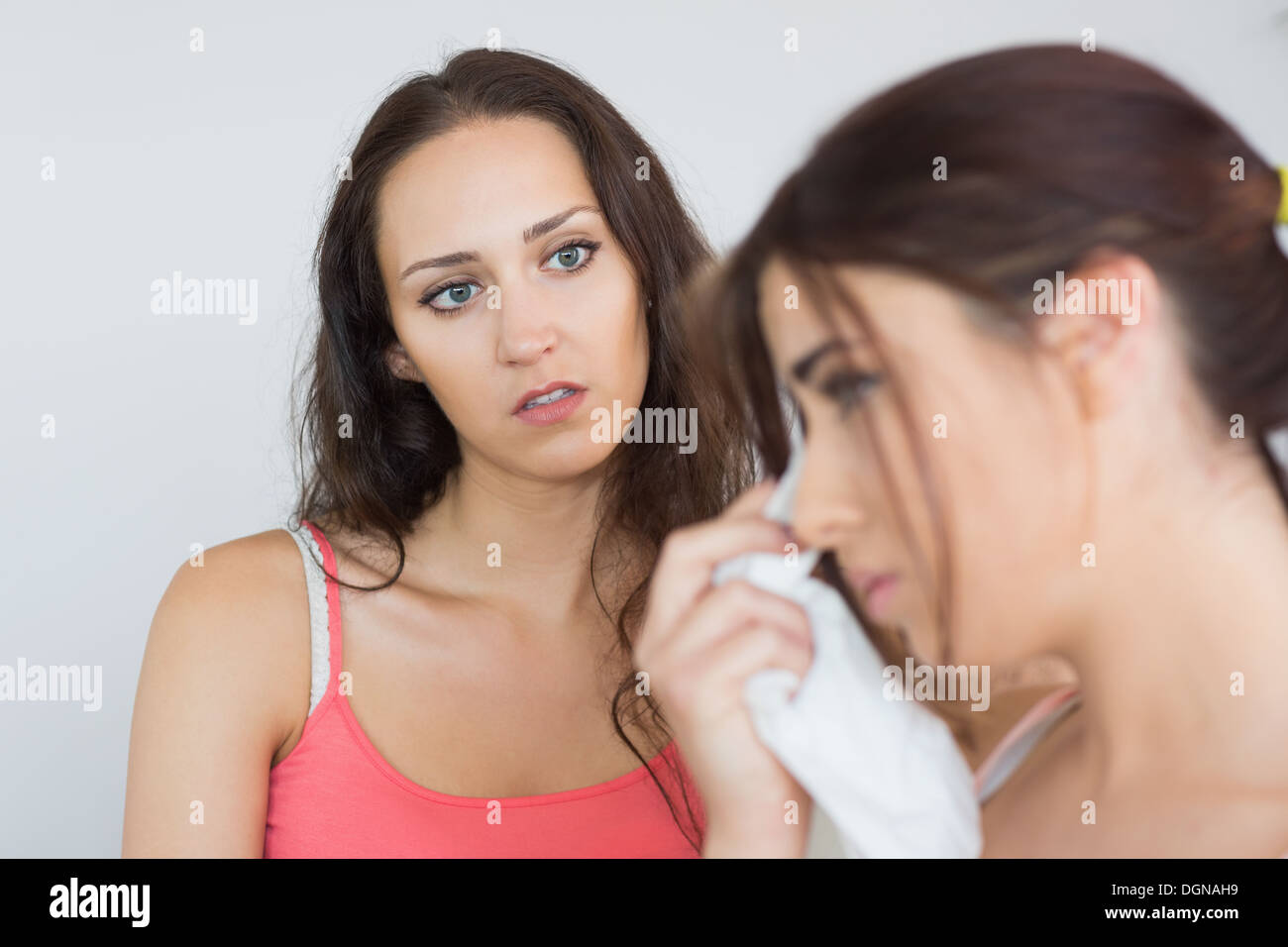 Crying woman sitting with her friend Stock Photo