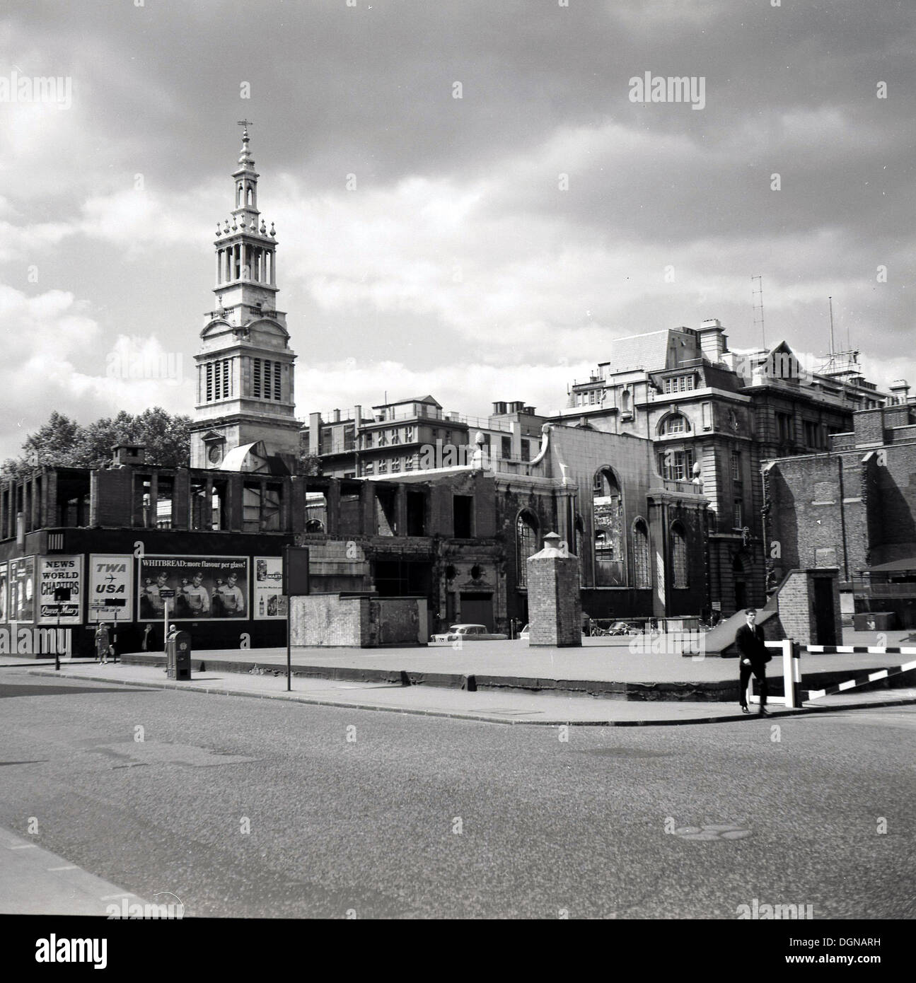 1950s, historical, post WW2 bomb damaged buildings, Central London, England, UK, with billboards. Advertisements for Brtiish Sunday newspaper, the News of the World and American airline company, TWA can be seen displayed. Stock Photo