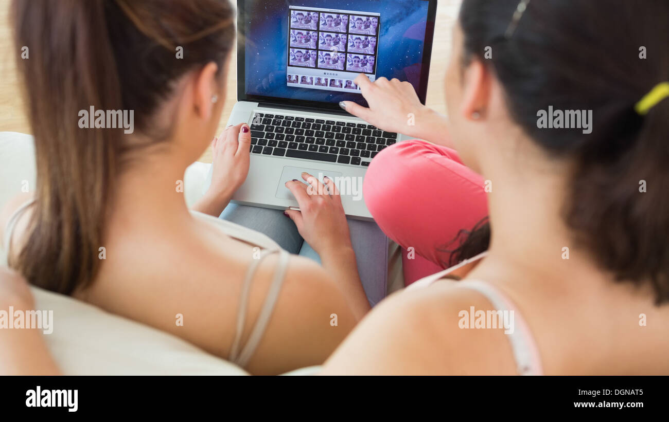 Two brunette young women working with a laptop Stock Photo