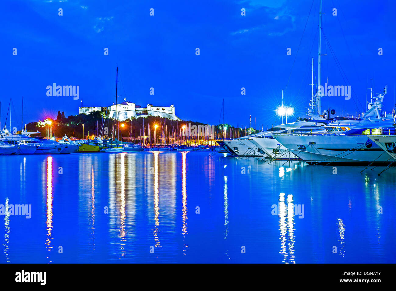 Europe, France, Alpes-Maritimes, Antibes. Marina and Fort Carre at Twilight. Stock Photo