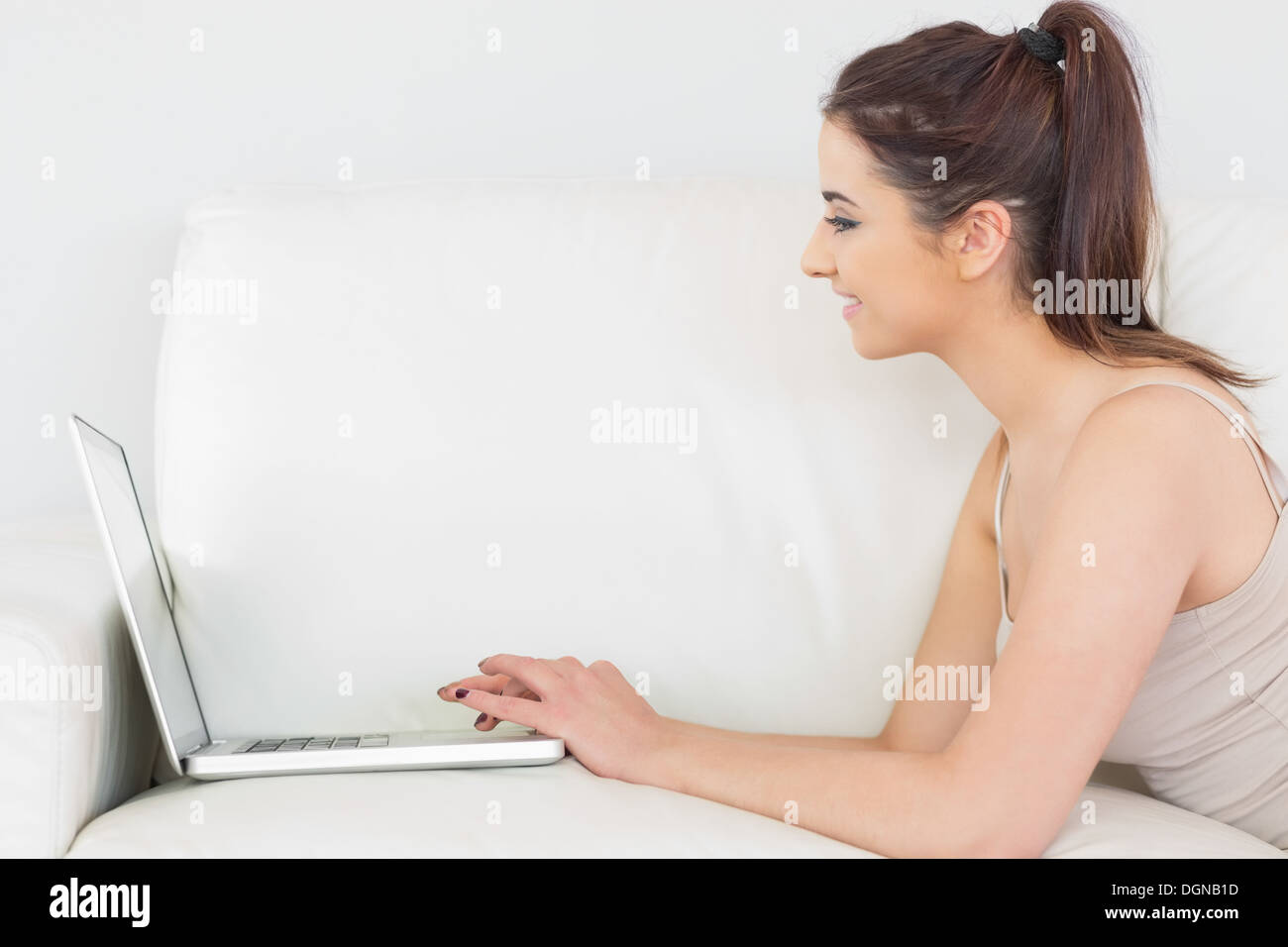 Glad brunette woman using her notebook Stock Photo