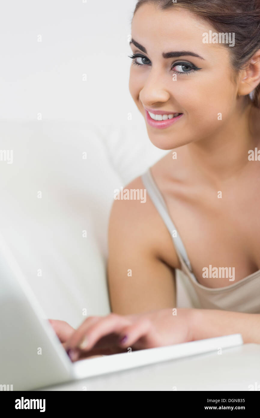Beautiful woman smiling at the camera using her laptop Stock Photo - Alamy
