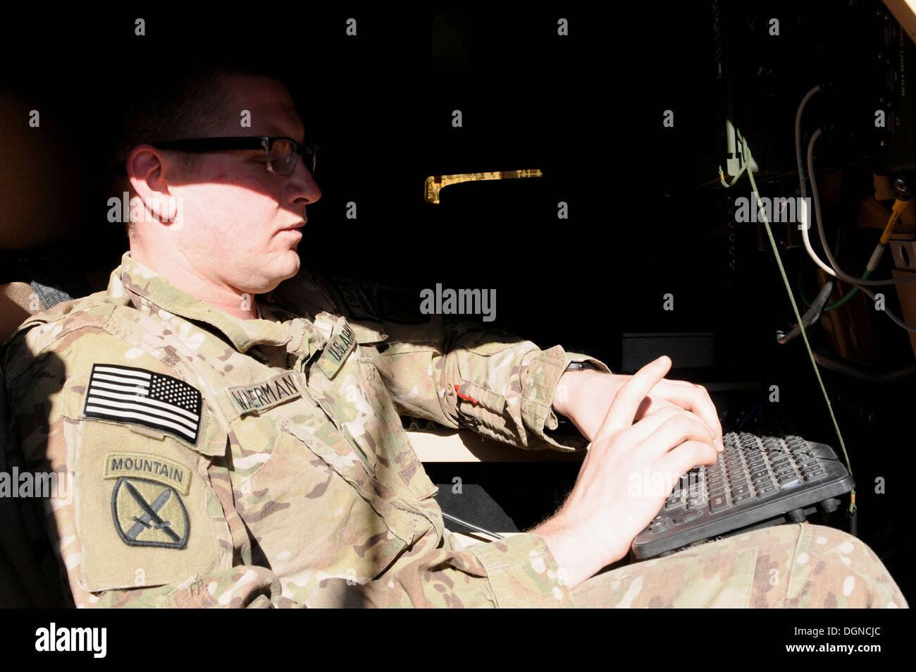 U.S. Army Capt. Charles Waterman takes a few moments to familiarize himself with the CS-13 system in a Point of Presence truck at Forward Operating Base Tagab Oct. 17, 2013. Waterman is a Newport, Wash., native, who serves as the Security Force Advise and Stock Photo