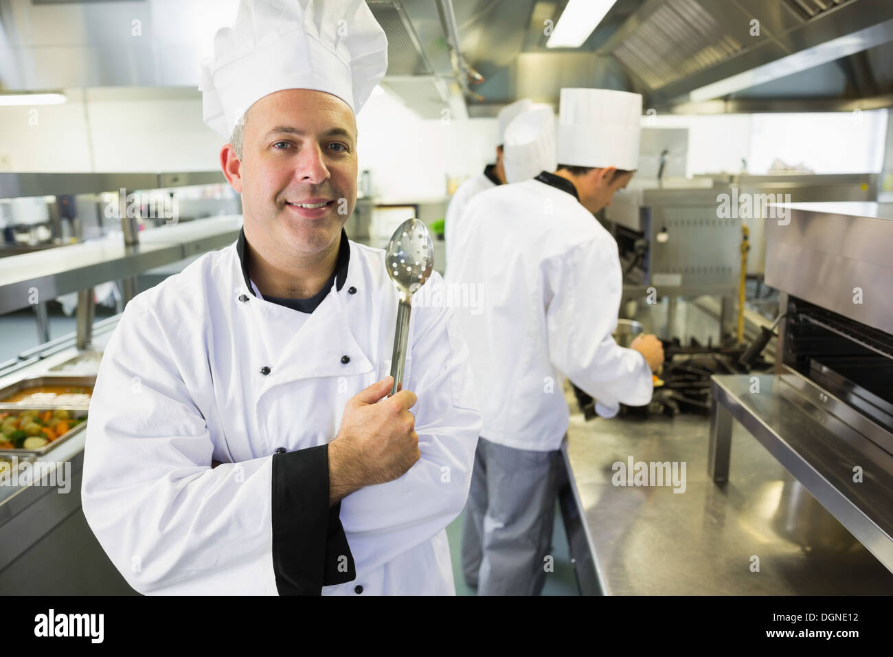 Experienced male chef posing in a kitchen Stock Photo
