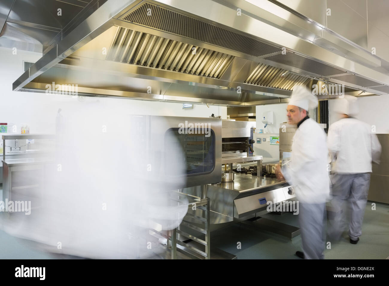 Team of chefs working in a kitchen Stock Photo