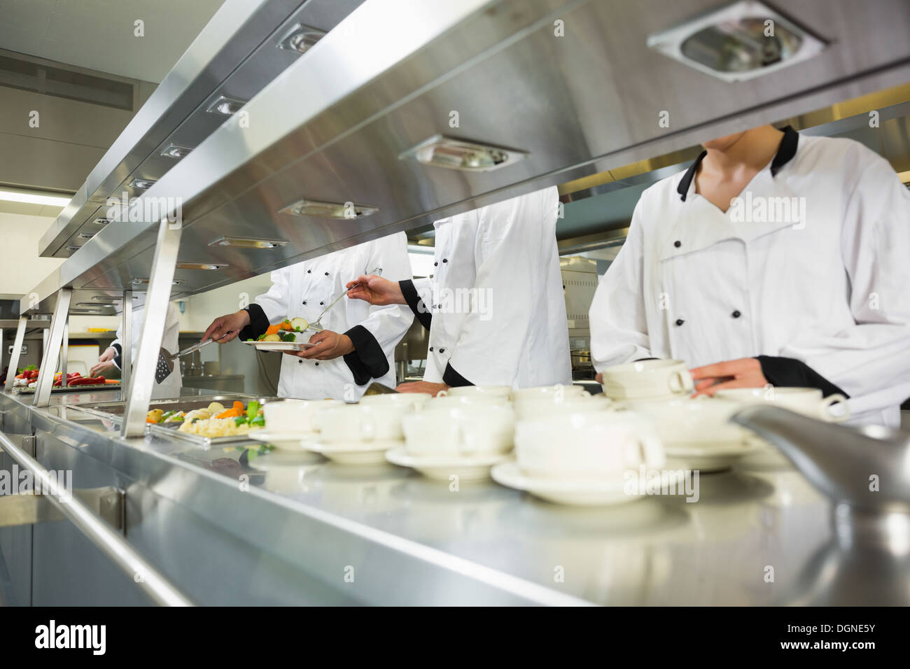 Four chefs working in a kitchen Stock Photo