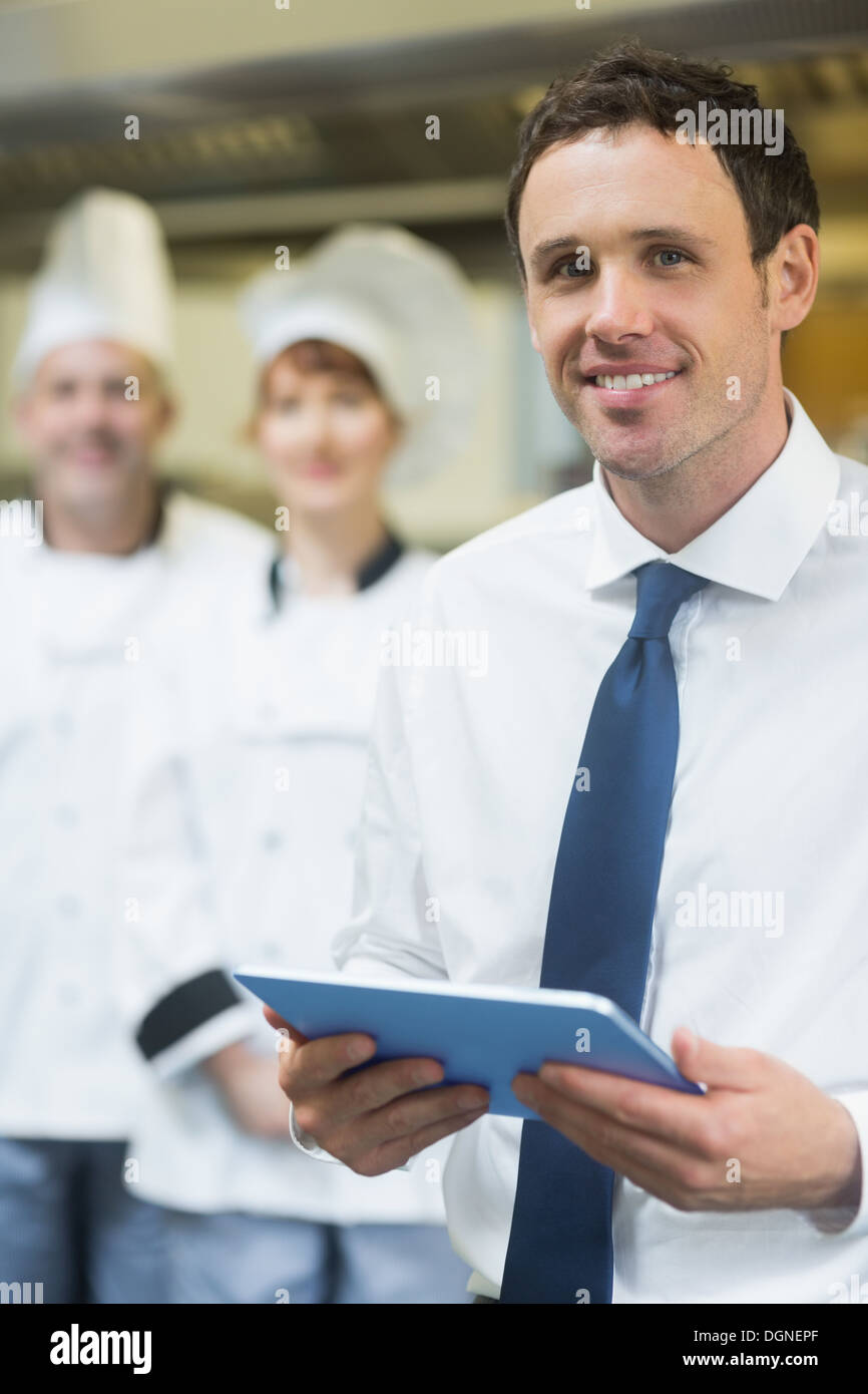 Young restaurant manager holding his tablet Stock Photo