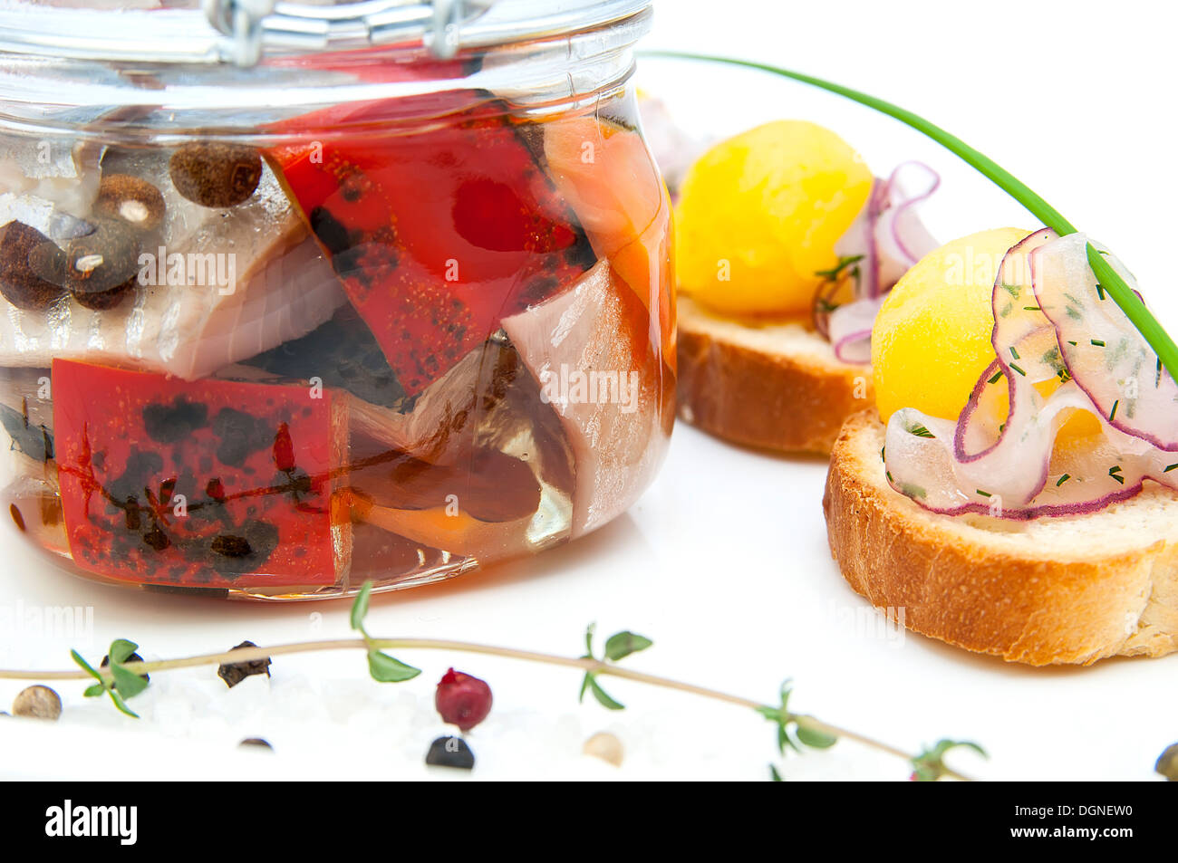 pickled herring in a glass jar with potato canapes Stock Photo Alamy