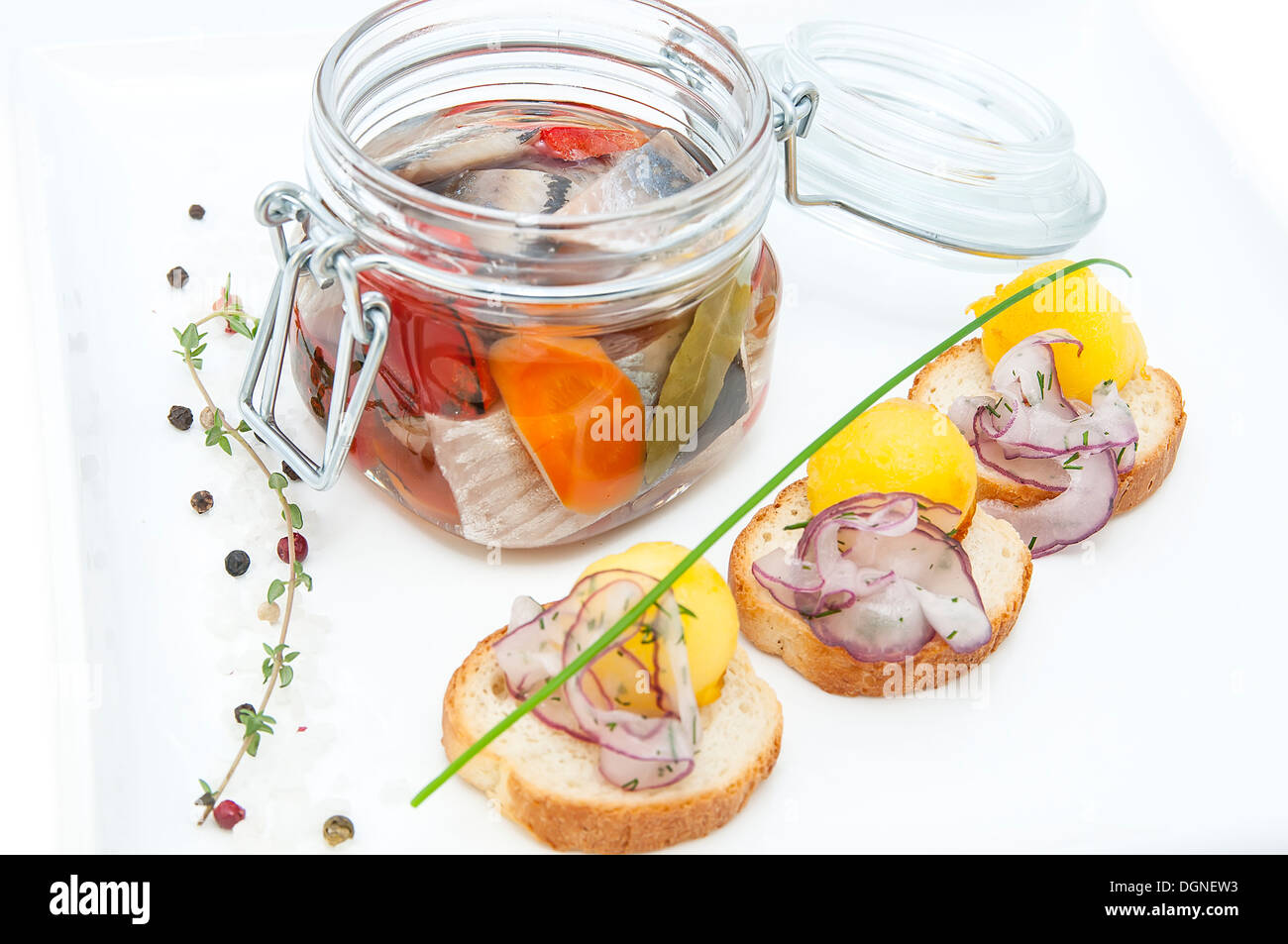 pickled herring in a glass jar with potato canapes Stock Photo Alamy