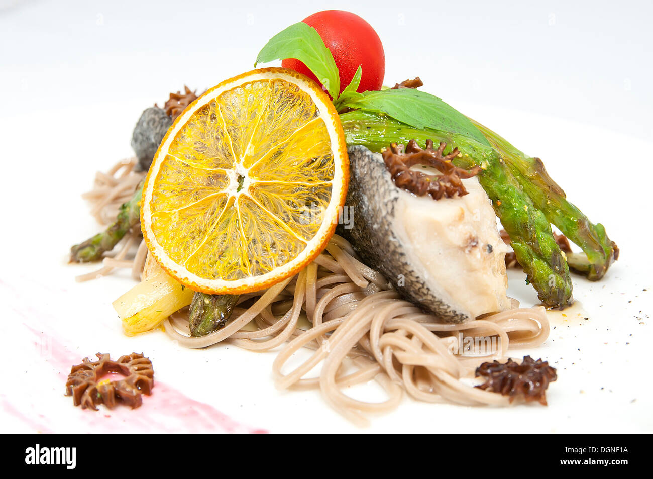 baked fish with spaghetti and mushrooms and vegetables Stock Photo Alamy