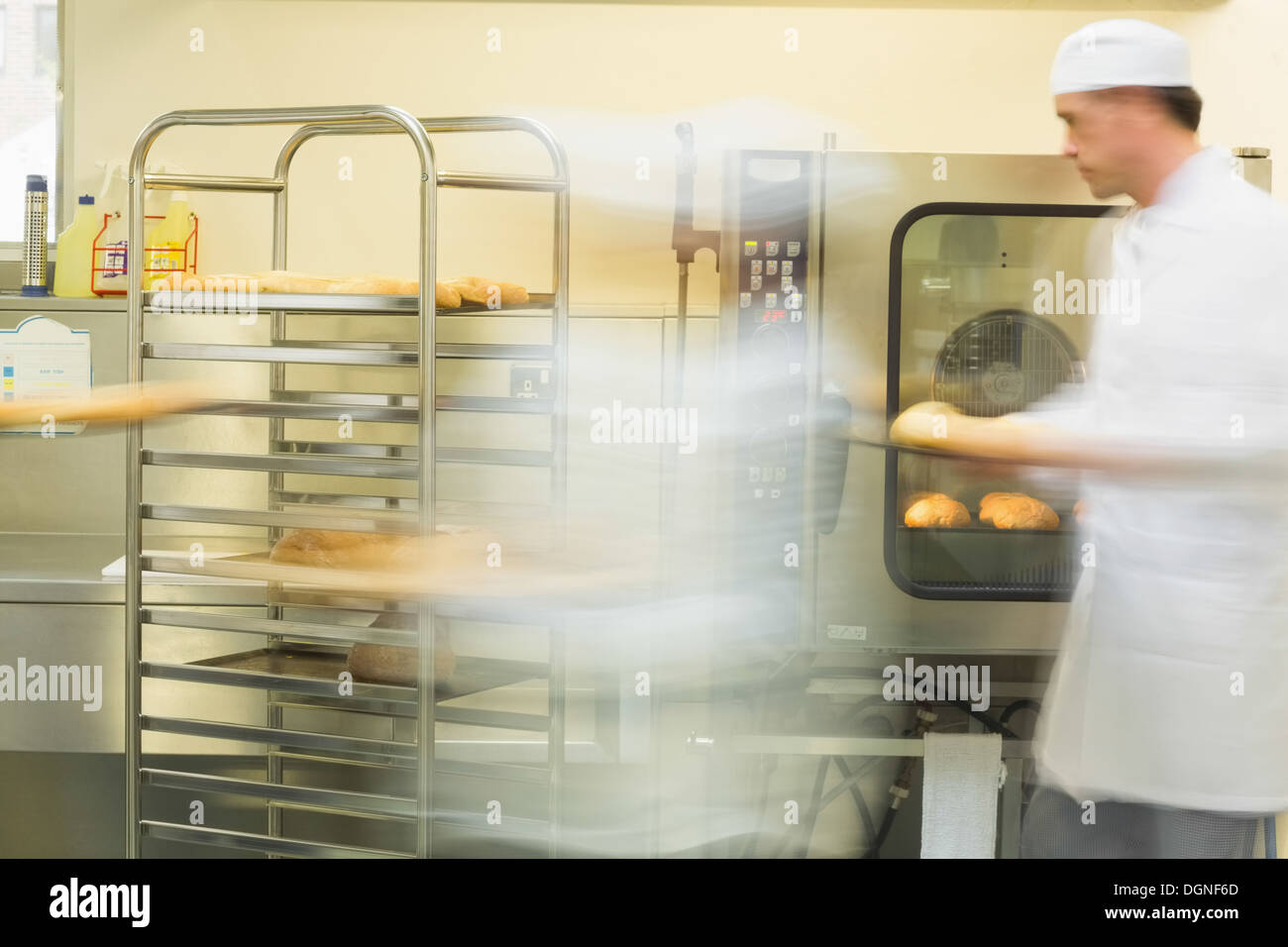 Two bakers working in the kitchen Stock Photo Alamy
