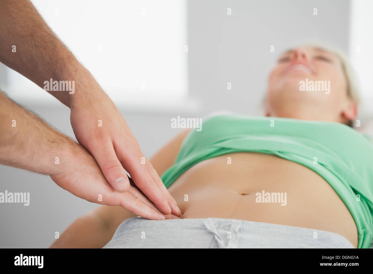 Physiotherapist pressing patients pelvis Stock Photo