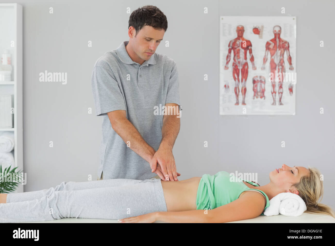 Physiotherapist examining patients pelvis Stock Photo