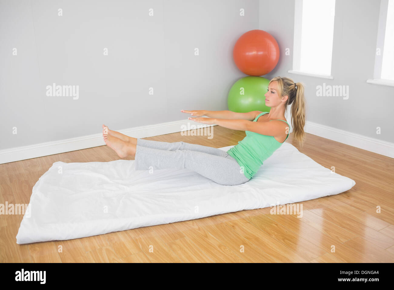 Blonde woman doing physical exercise Stock Photo