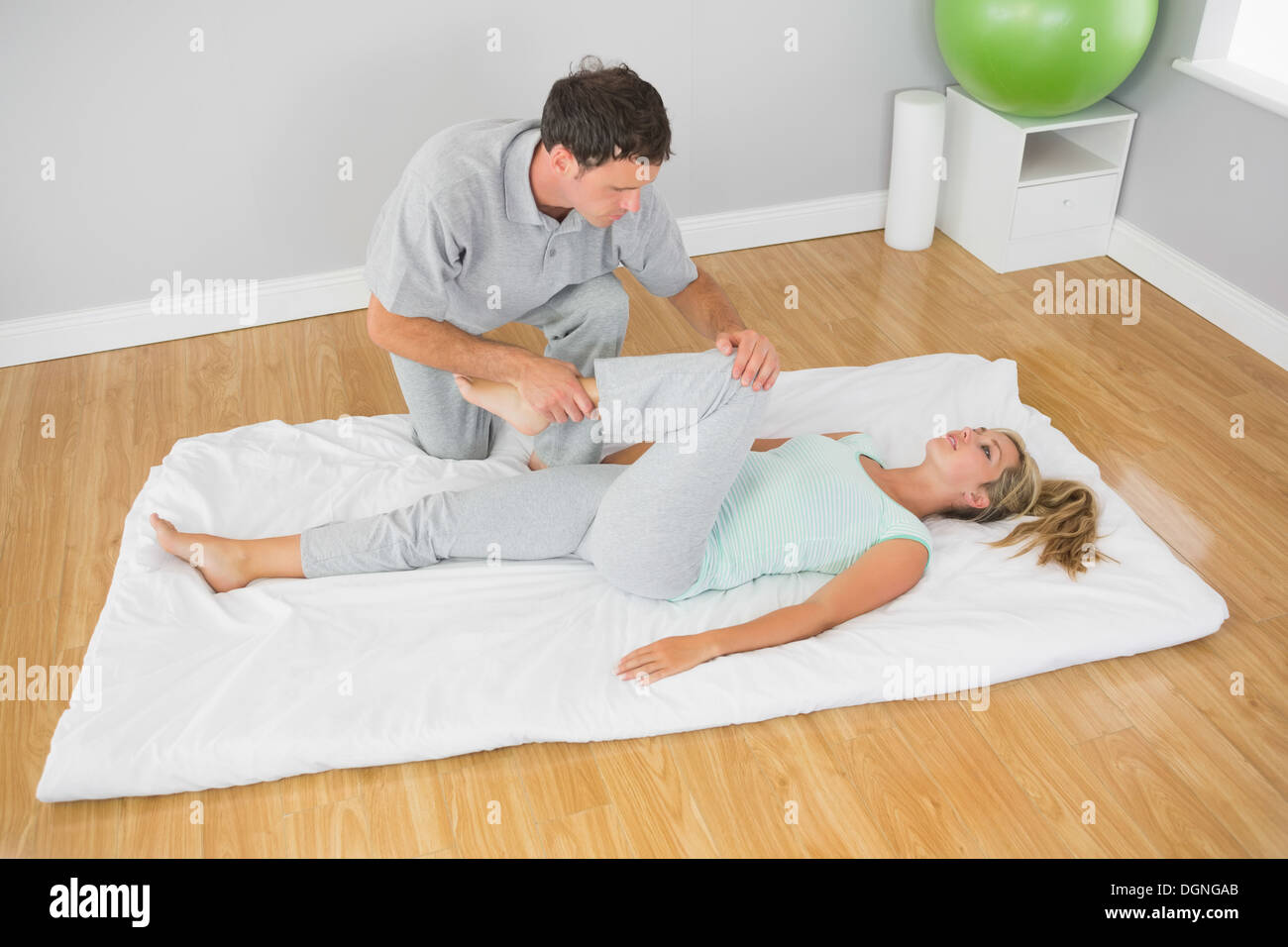 Man stretching leg on floor hi-res stock photography and images - Alamy
