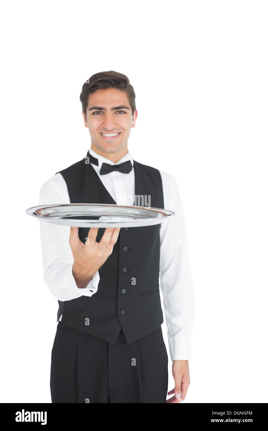 Young waiter presenting an empty tray Stock Photo