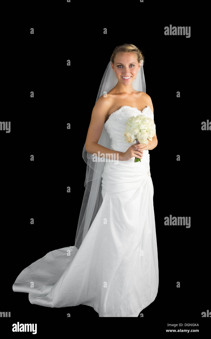 Gorgeous young bride posing holding a bourquet Stock Photo