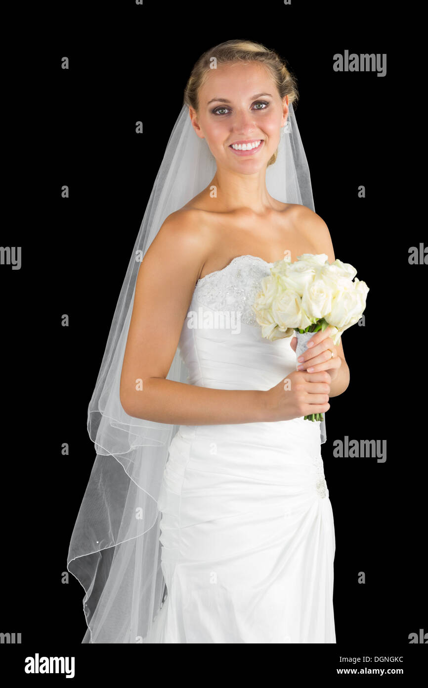 Beautiful young bride posing holding a bouquet Stock Photo - Alamy