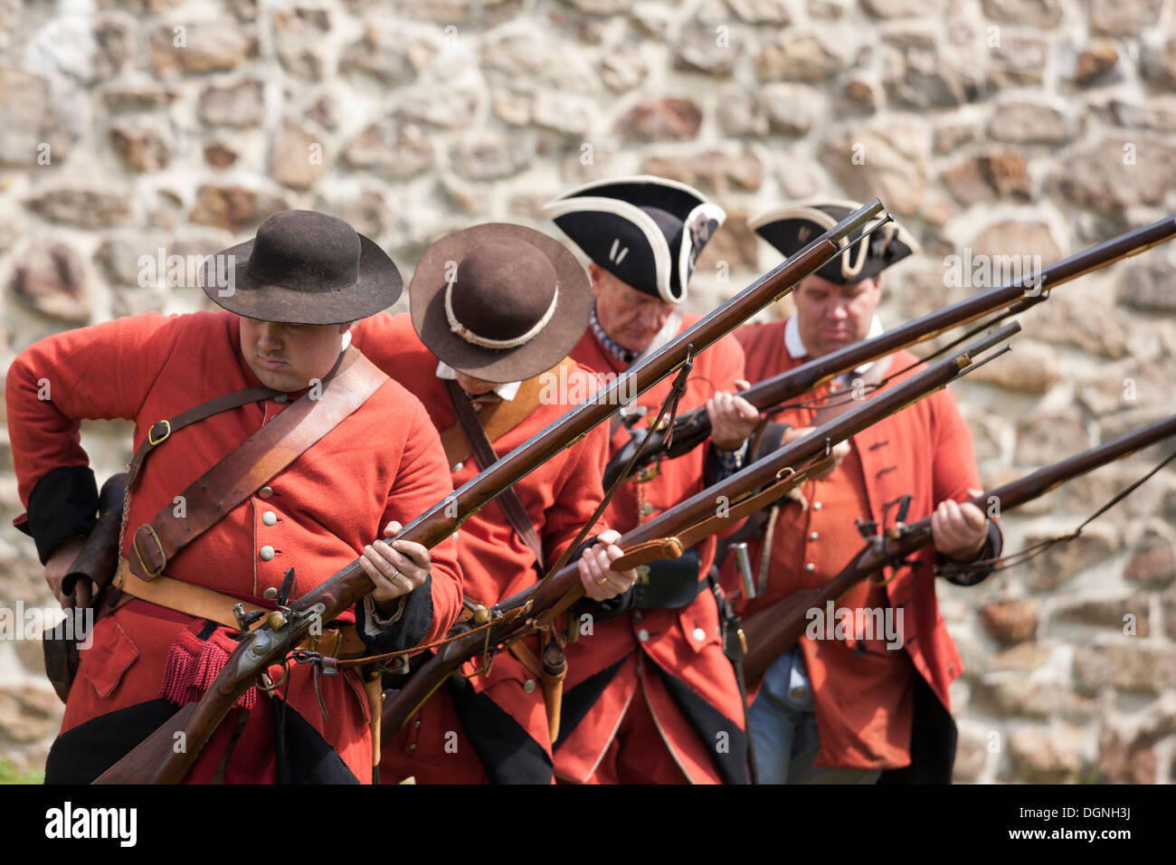 Soldiers loading flintlock muskets in re-enactment French & Indian American Revolution Revolutionary War of Independence Stock Photo
