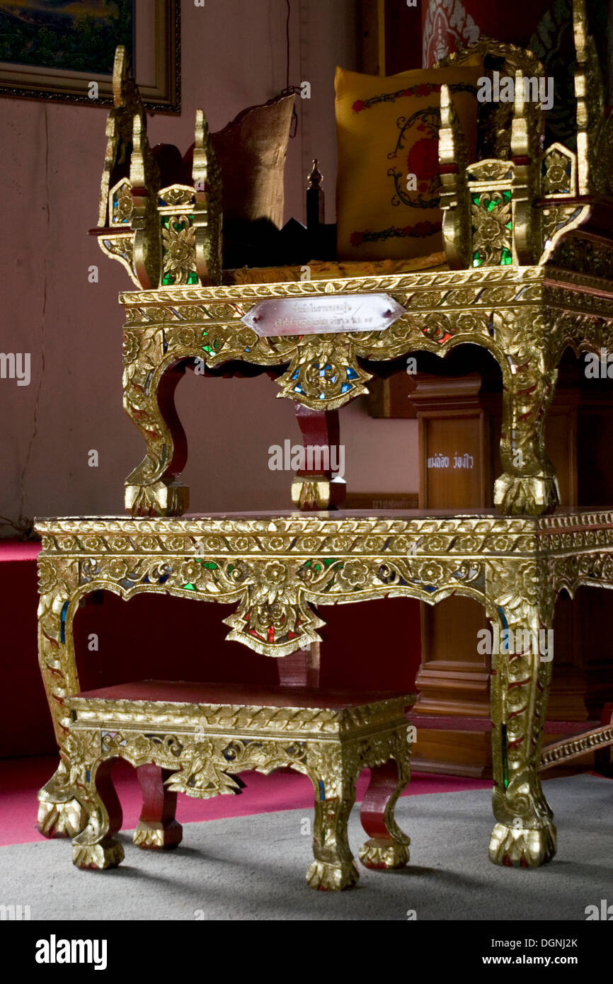 A Beautiful Ornate Golden Chair Rests On Top Of A Gold Table