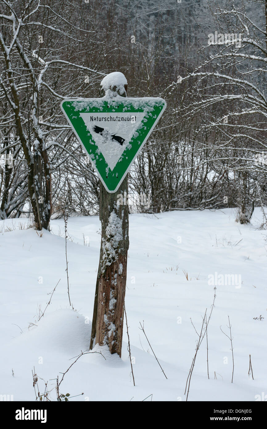 Snow-covered sign Naturschutzgebiet, German for nature reserve Stock Photo