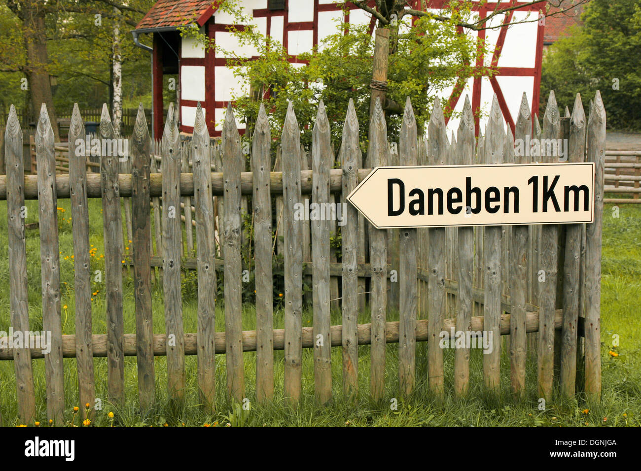 Town sign 'Daneben' 1 km, German for 'off the mark' or 'off target', funny road sign, Freilichtmuseum Hessenpark open-air museum Stock Photo